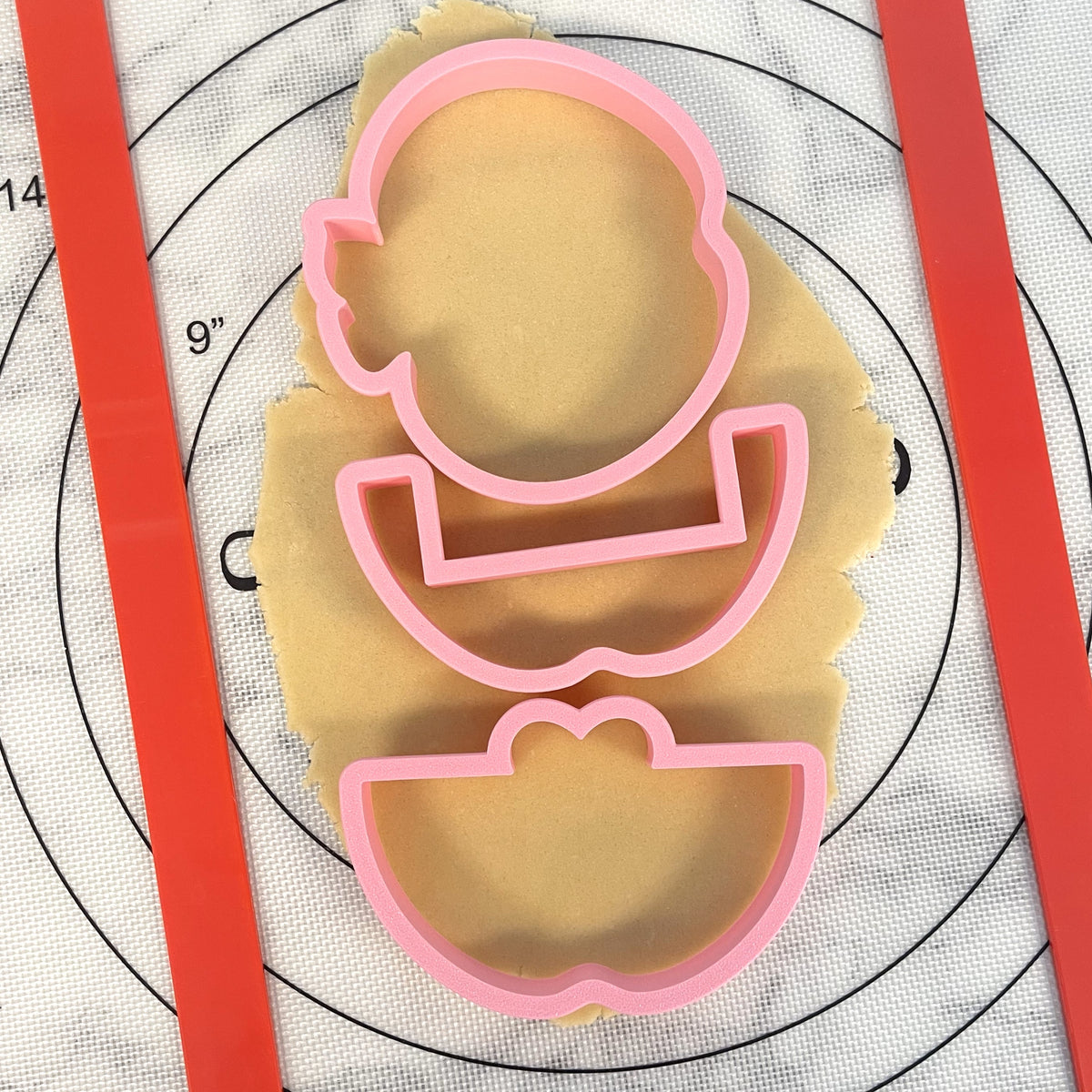 Pink plastic cookie cutter shaped like a cartoon character from 3pc apple gift card holder cookie cutter set