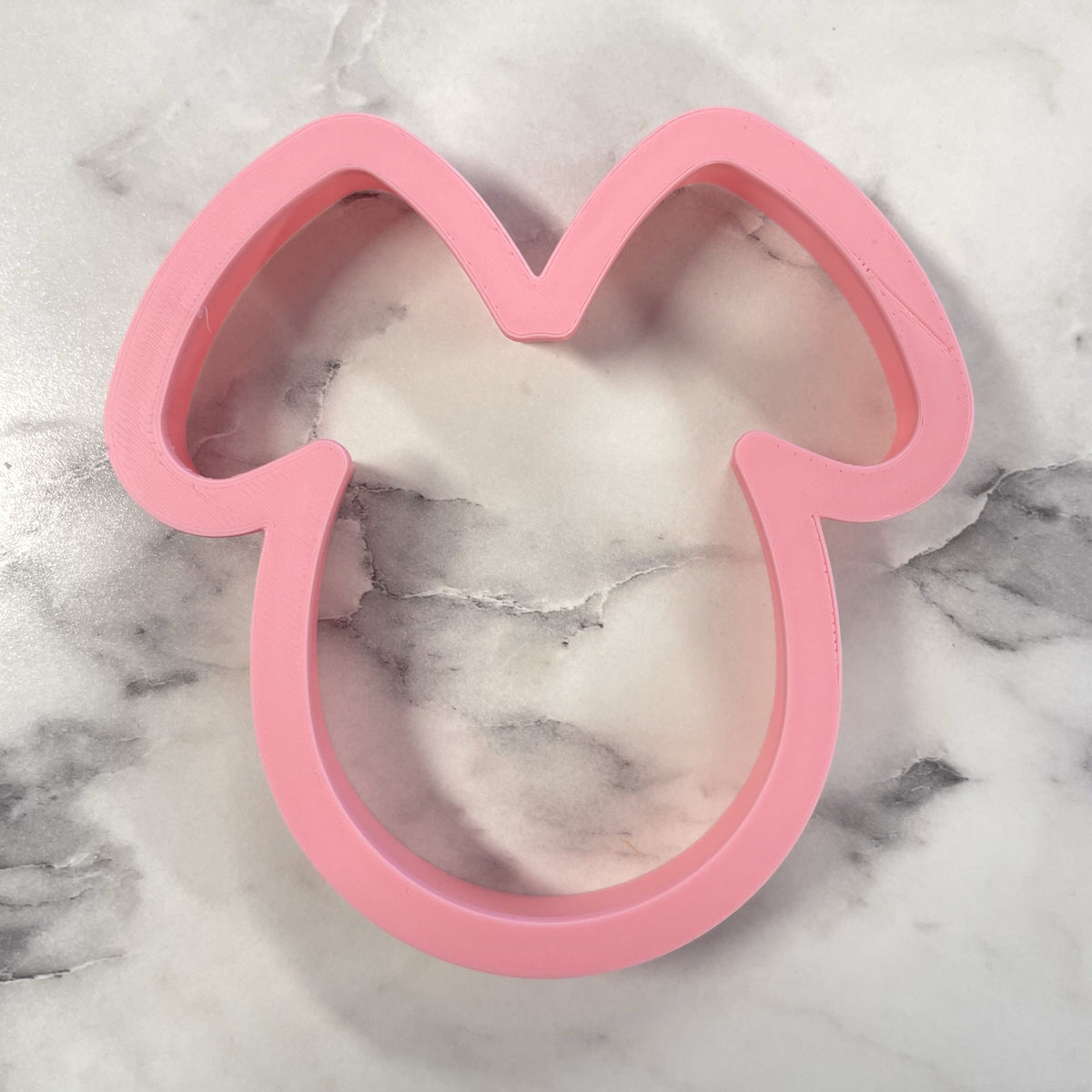 Pink silicone bunny costume cookie cutter shaped like minnie mouse head for baking and crafting use