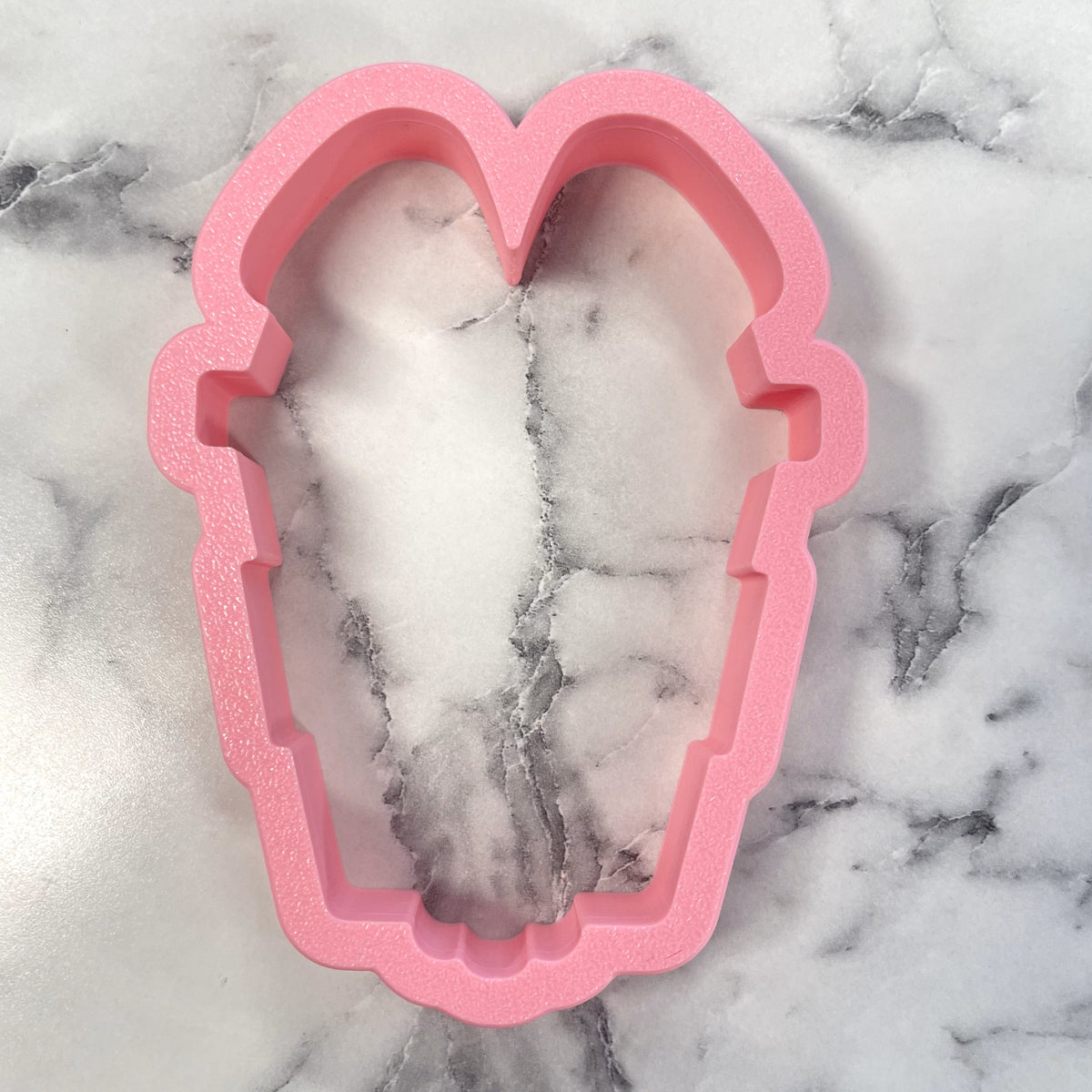 Pink foam coffin-shaped mold for bunny latte cookie cutter ideal for baking and crafts