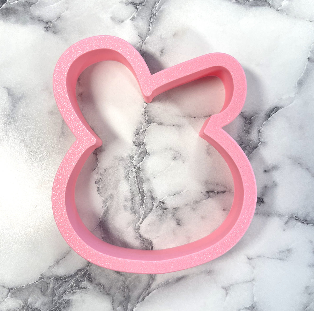 Pink bunny with floppy ear cookie cutter with smooth slightly textured surface for baking and crafts