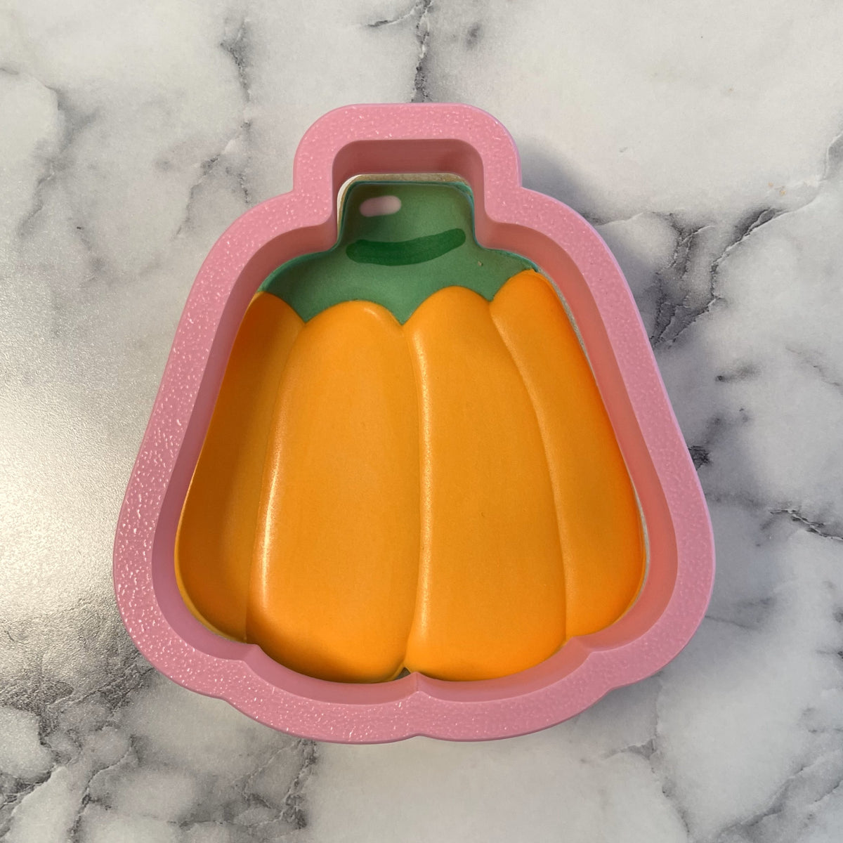 Pink glittery pumpkin-shaped cookie cutter with green stem and orange body for candy pumpkin flour box club baking