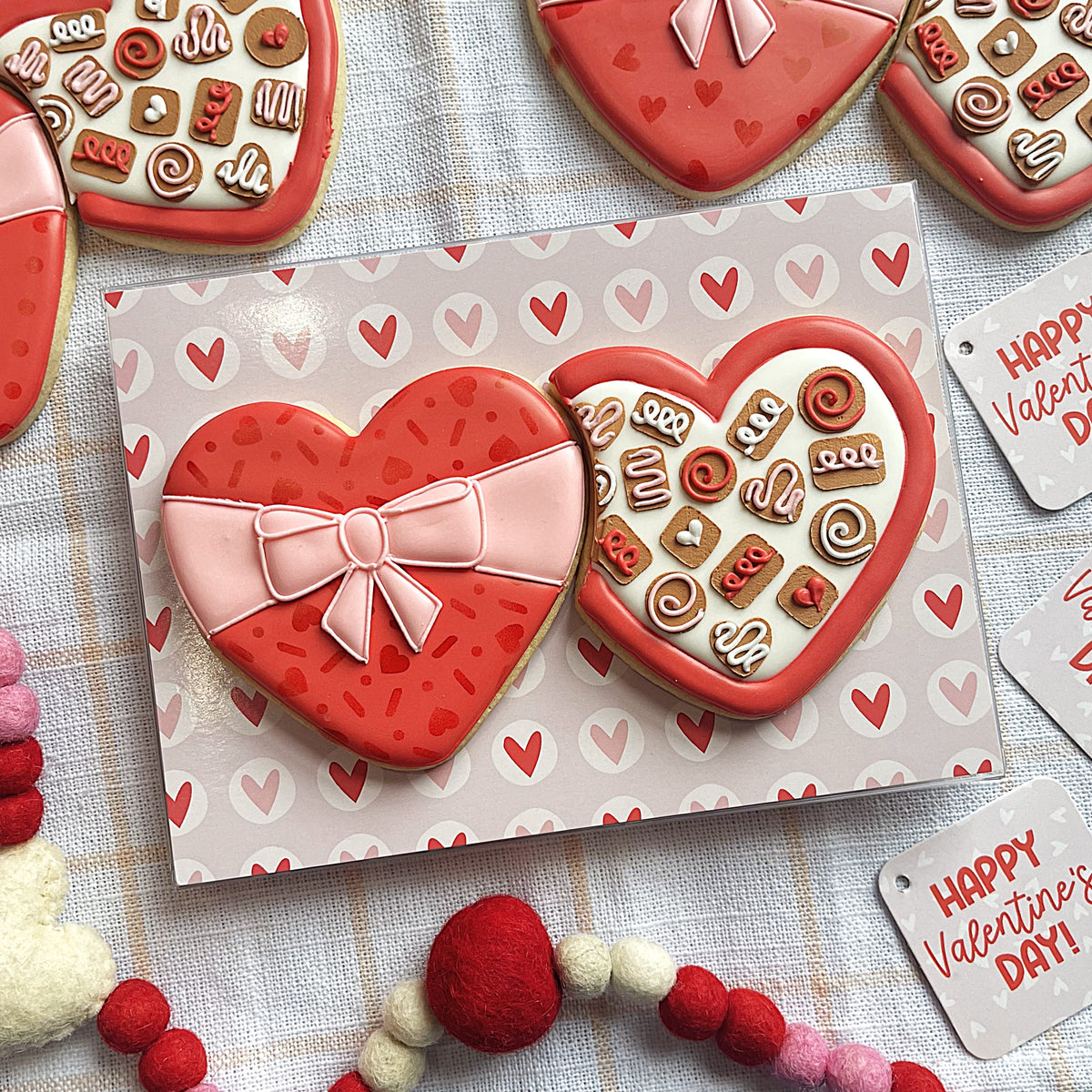 Valentine 2025 cookie cutter set red heart-shaped cookie with pink icing bow and sprinkles designed like a gift box