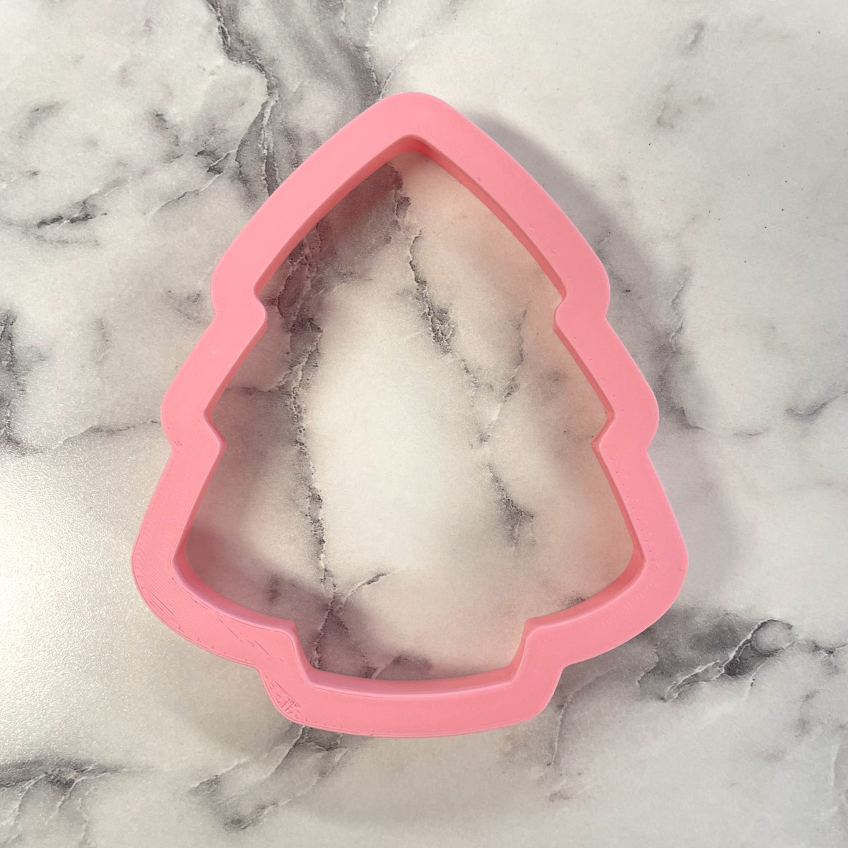 Pink silicone christmas tree cake cookie cutter ideal for festive holiday baking and cookie shaping