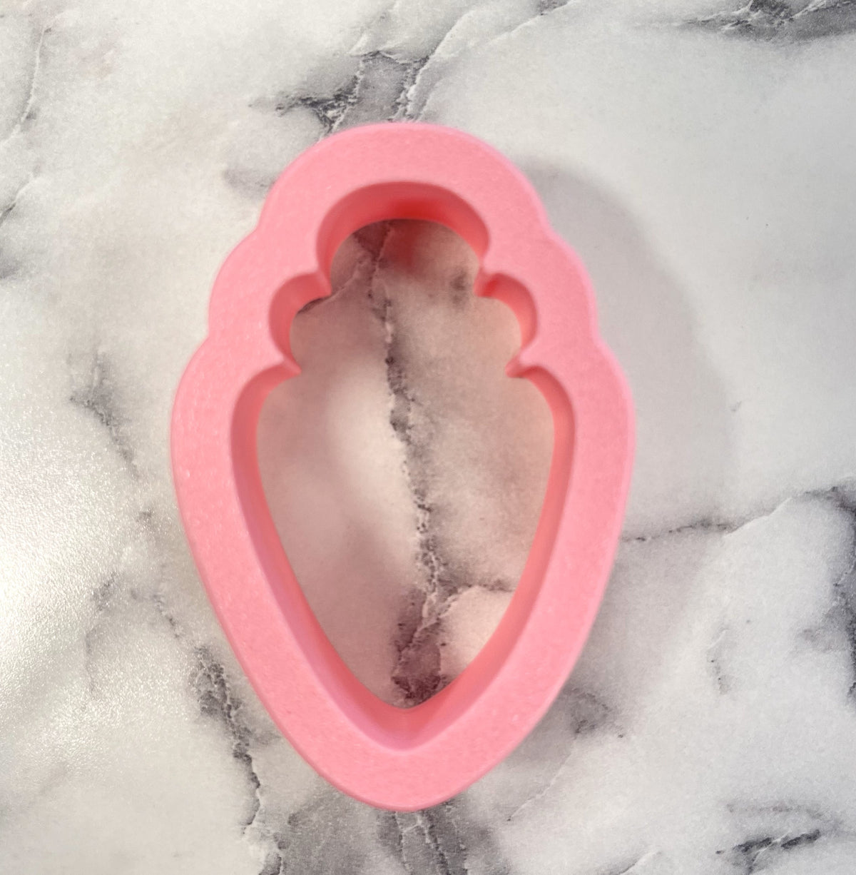 Pink silicone chunky carrot cookie cutter mold with scalloped edges for baking and shaping cookies