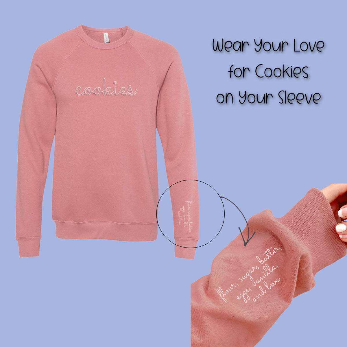 A soft pink long-sleeved mauve sweatshirt with cookies embroidered in white script across the chest