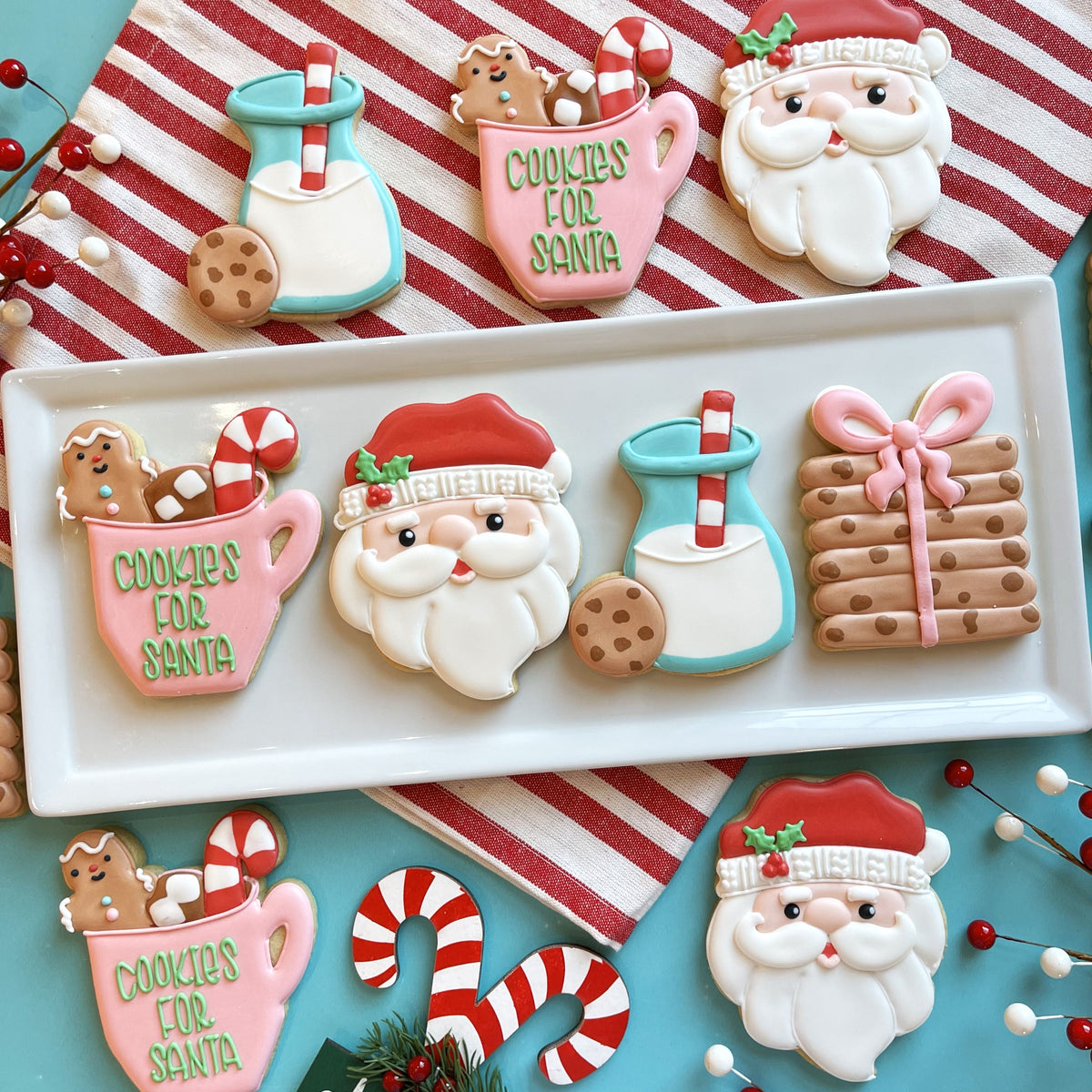 Pink sugar cookie shaped like a mug with green icing reading cookies for santa from cookies for santa cutter bundle