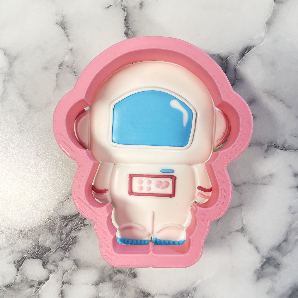 Cute astronaut cookie cutter pink silicone cake mold with white interior and blue visor accents for baking