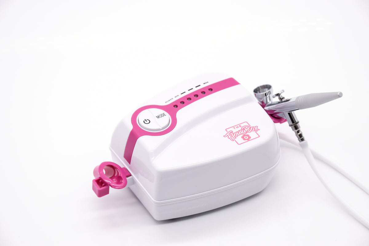 Pink and white 5-speed flour box airbrush system with silver nozzle designed for precise airbrush application