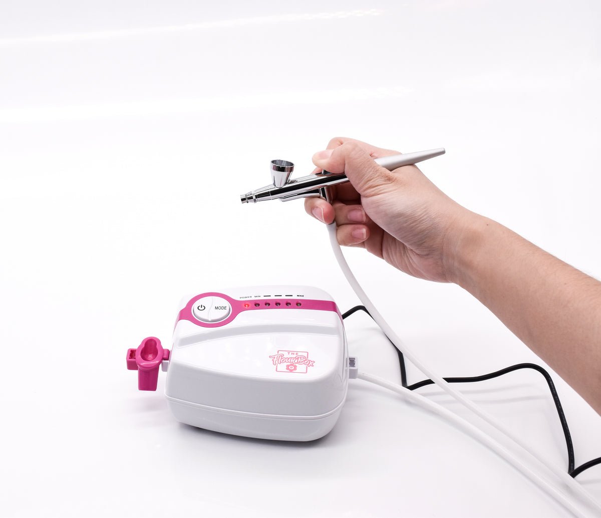 Pink and white 5-speed flour box airbrush system with silver metal nozzle for detailed airbrushing tasks
