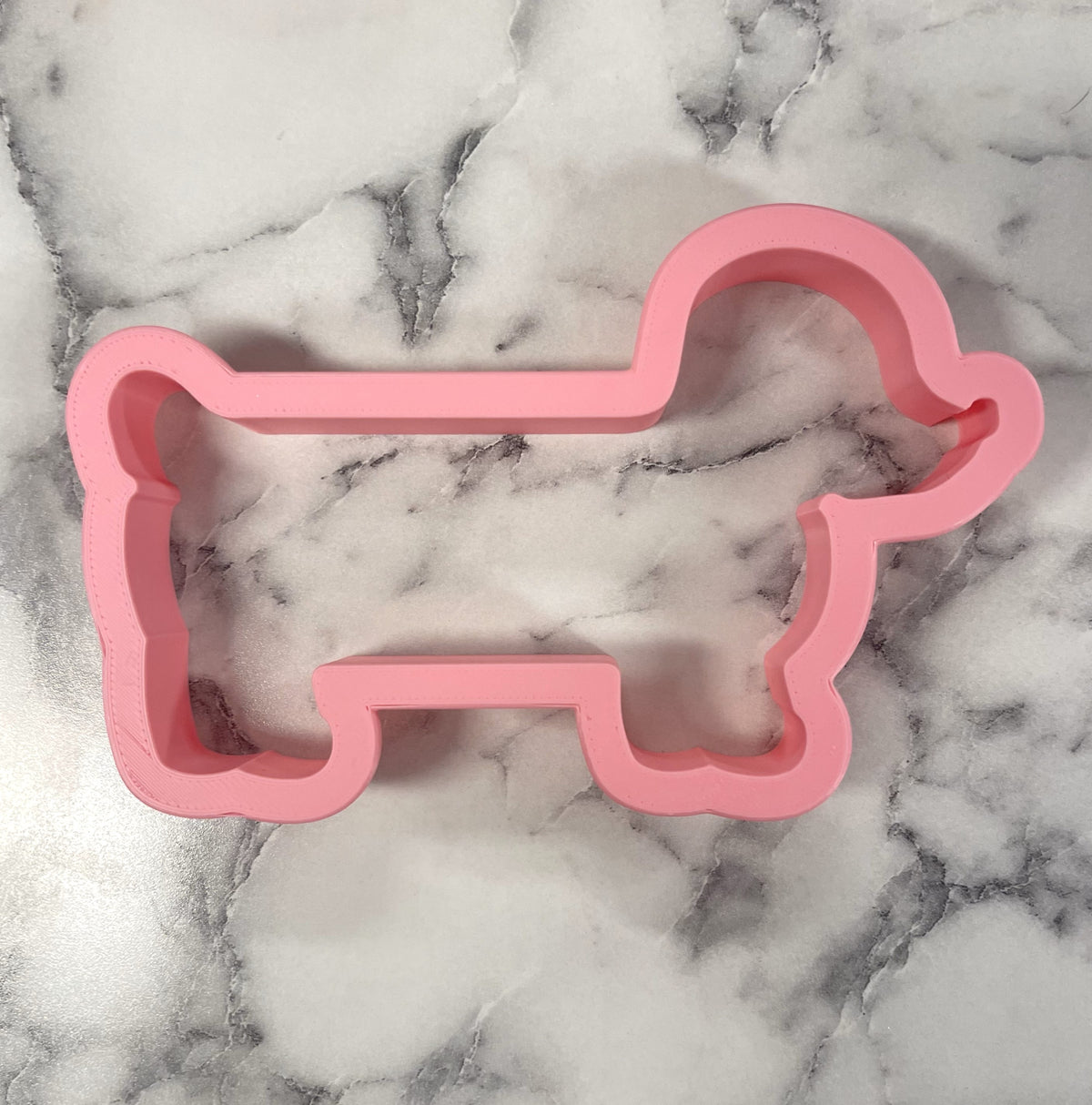 Pink silicone dachshund cookie cutter shaped for baking and fun dog-themed treats