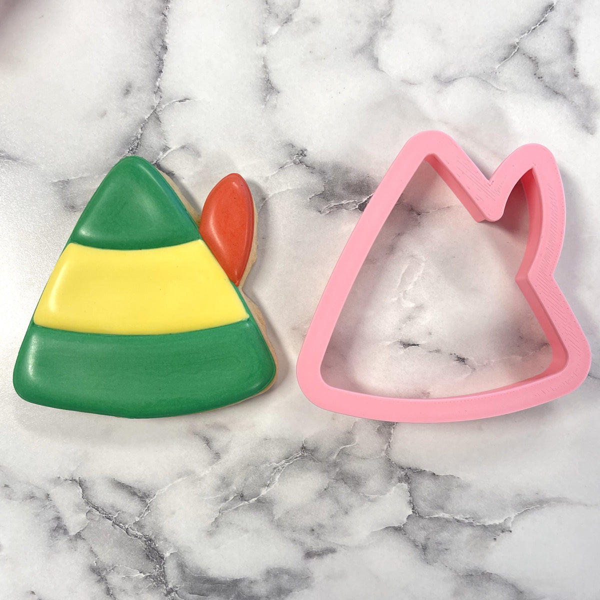 A pink silicone elf hat cookie cutter used for christmas themed baking and decorating