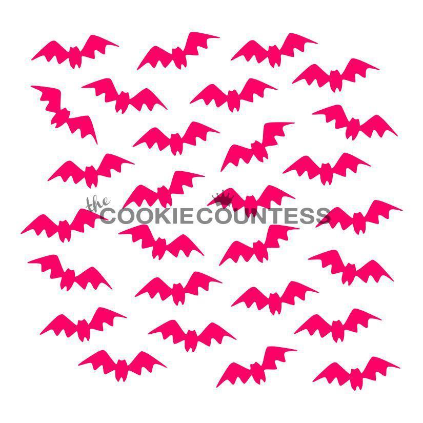 Bright pink bat-shaped paper cutouts scattered as part of a halloween stencil bundle for festive crafting projects