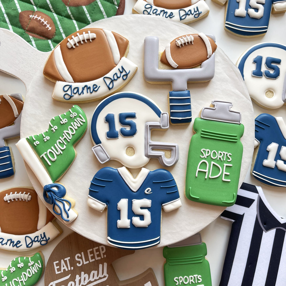 Blue and white football jersey cookie with number 15 made using the team flag cookie cutter for sports themed treats