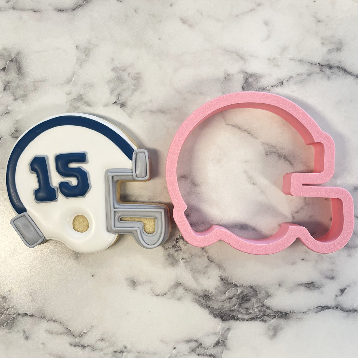 Football helmet cookie cutter in white and navy with number 15 gray faceguard accents and gold detail
