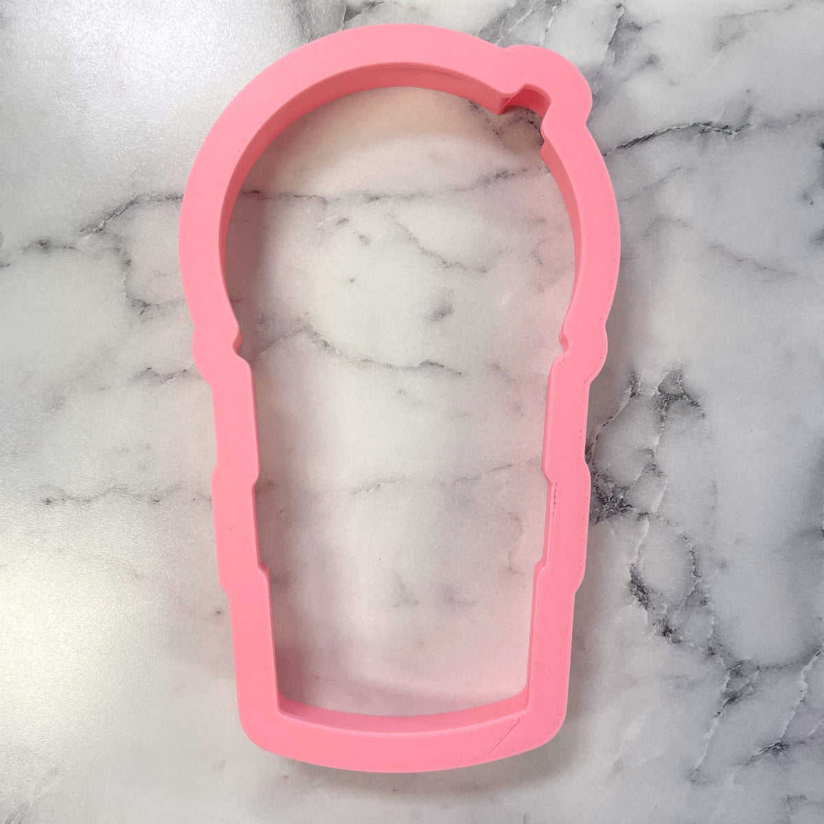 Pink silicone frappuccino cookie cutter shaped like a coffee cup for baking and crafting