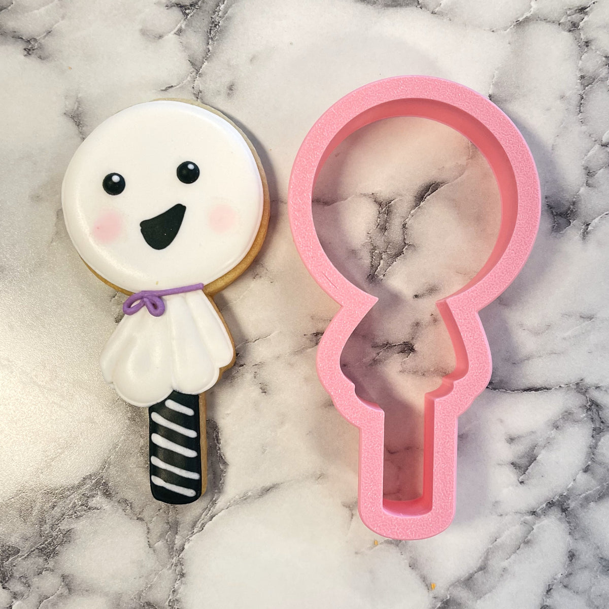 Pink silicone ghost-shaped cookie cutter with marbled interior for ghost lollipop flour box club baking use