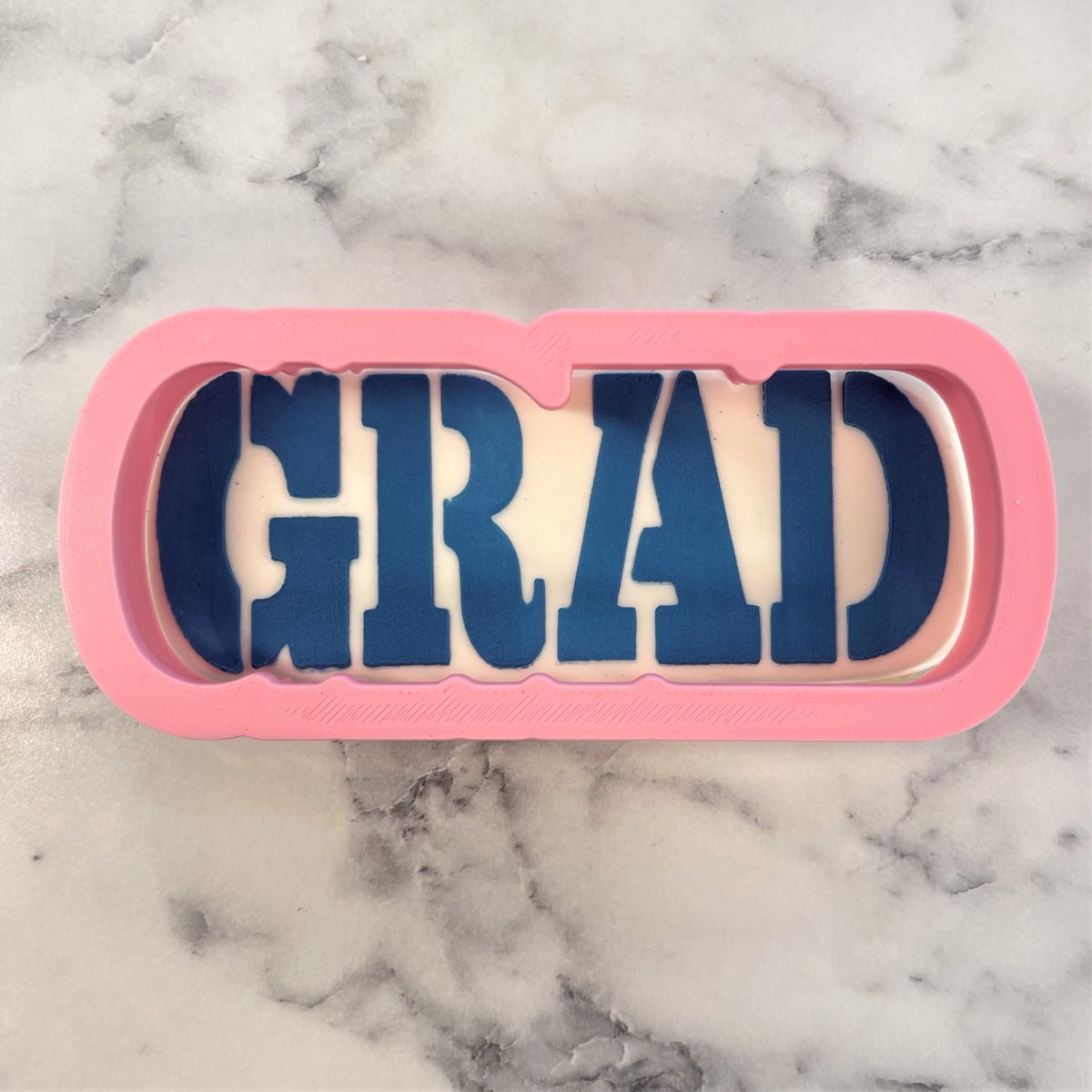 Pink silicone grad plaque flour box club cookie cutter with bold blue grad lettering and stencil for baking