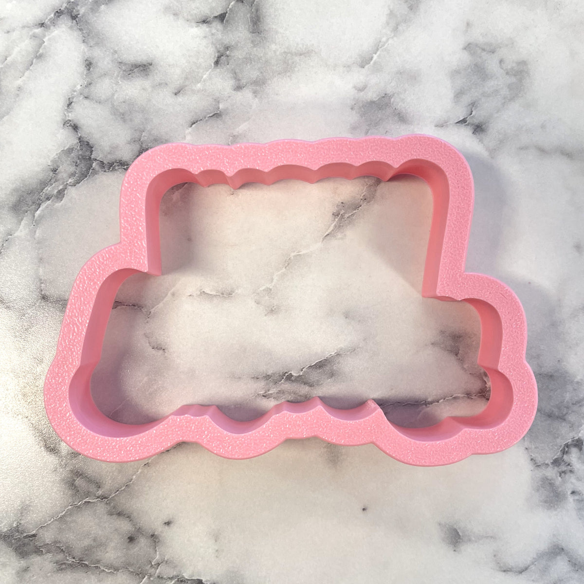 Pink foam cloud-shaped cookie cutter from happy birthday cookie cutter with stencil set for baking use