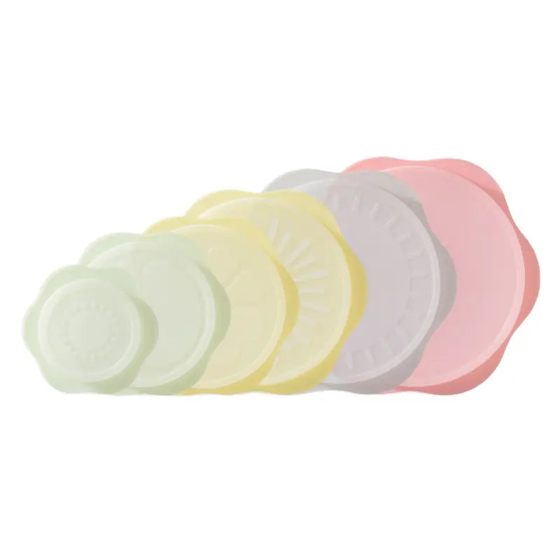 Set of five pastel scalloped-edge silicone food storage lids in green yellow white gray and pink for reusable bowl covers