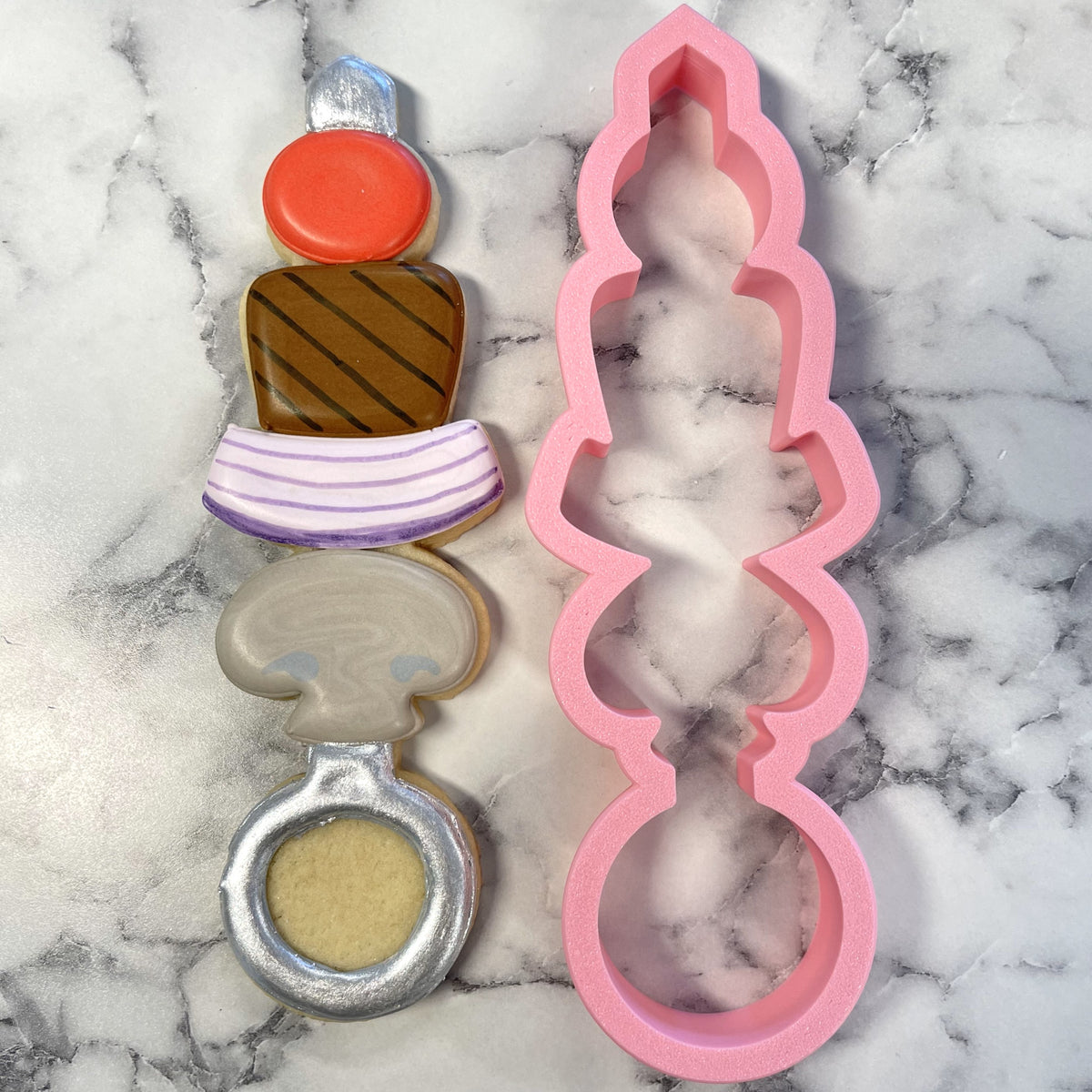 Pink silicone kabob large cookie cutter with wavy edges and tiered design for skewer-shaped cookies