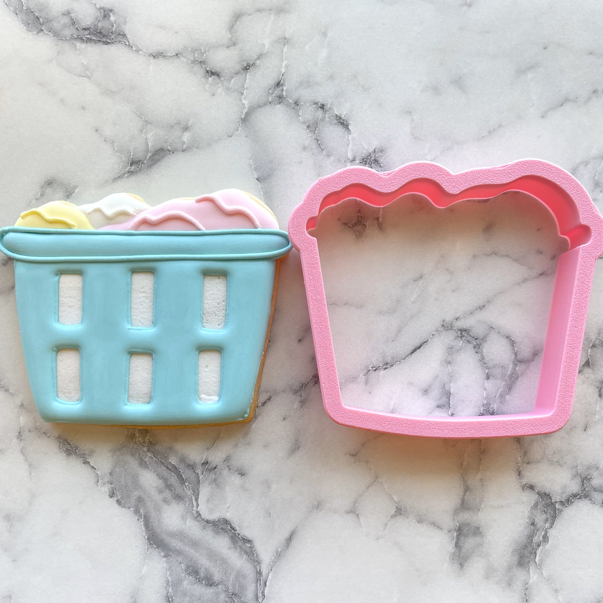 Laundry basket cookie cutter set in pink and light blue silicone with scalloped edges for baking and crafting
