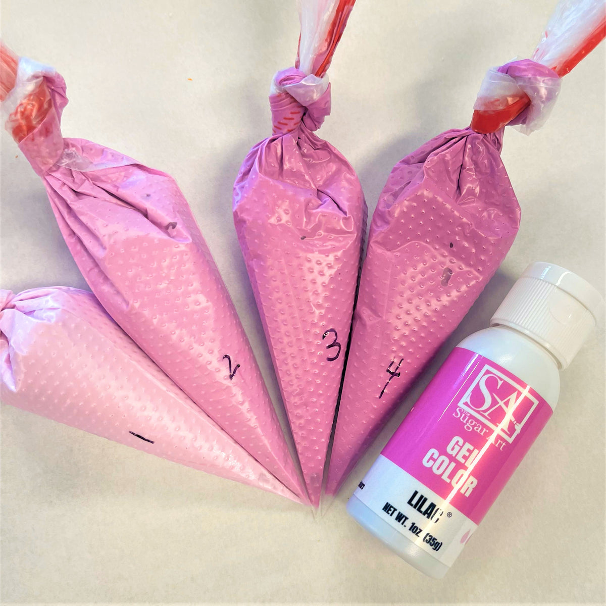 Pink glossy plastic piping bags with dotted texture and numbered markings for lilac the sugar art gel color sale