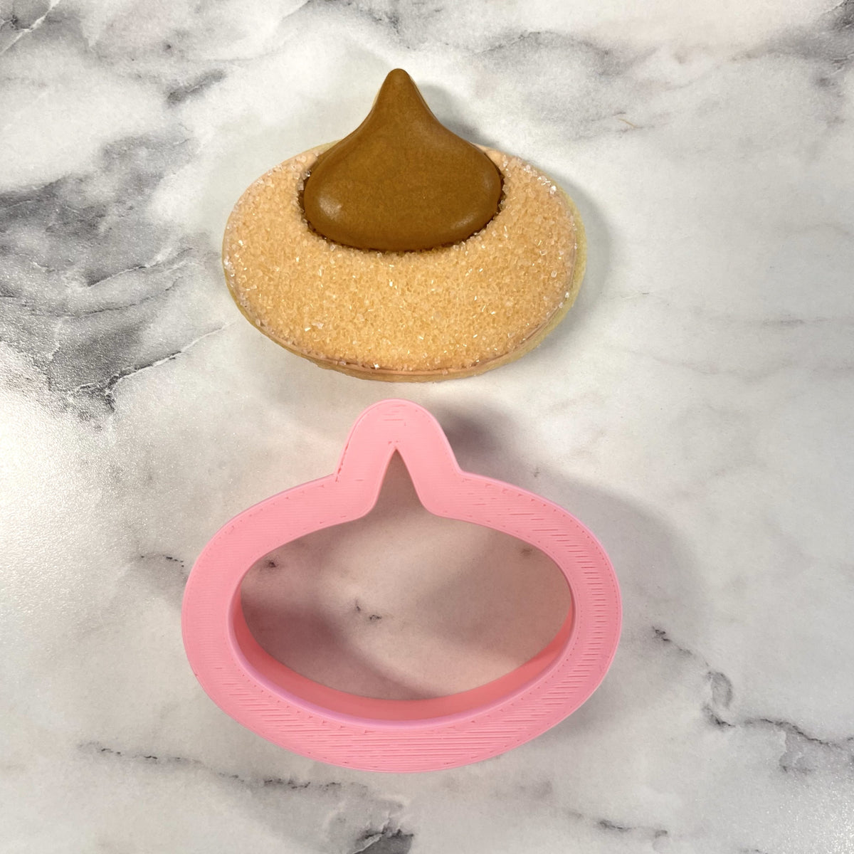 Pink plastic mini pb blossom cookie cutter shaped like a poop emoji for baking and decorating treats