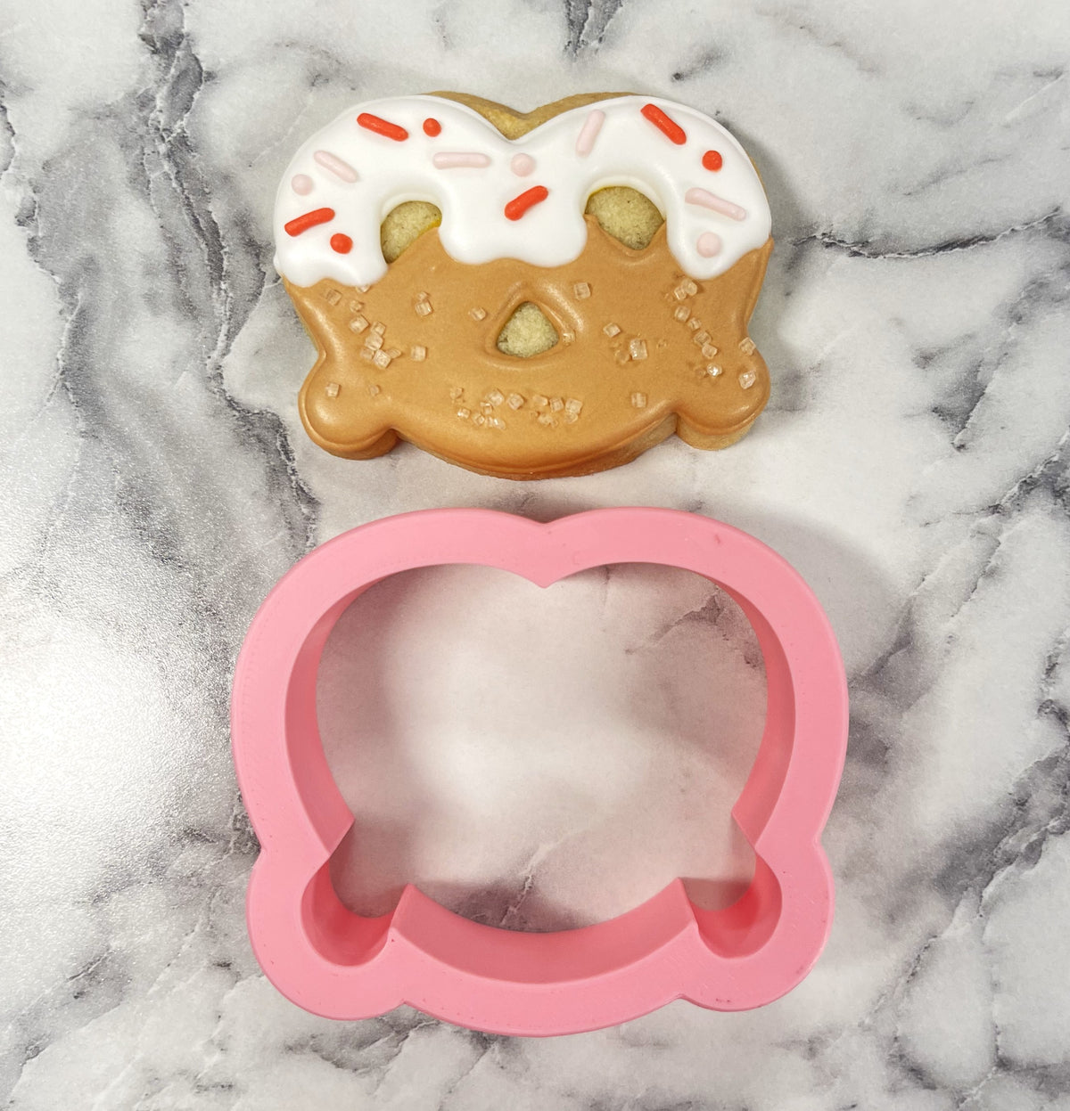 Mini pretzel pink silicone cookie cutter shaped like a donut with sprinkles for baking and crafting