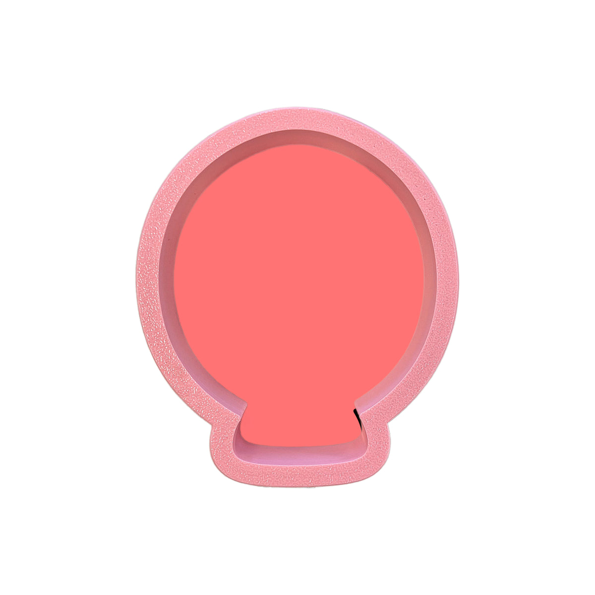 Pink silicone phone stand shaped like a seashell shown with mini marshmallow balloon cookie cutter product