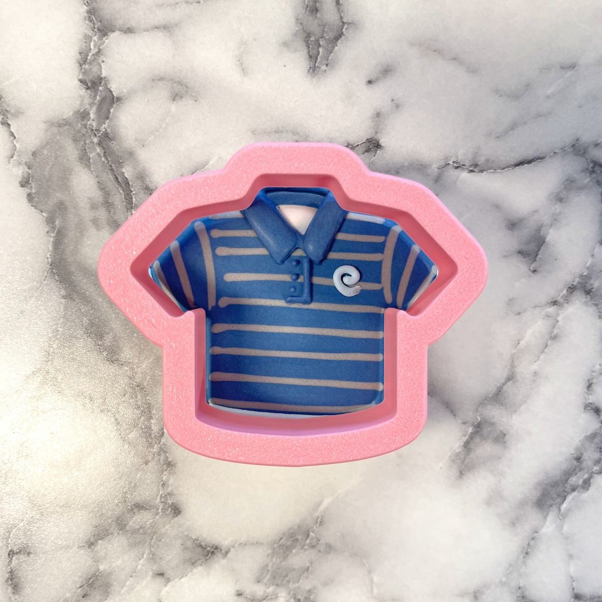 Pink silicone mini golf shirt cookie cutter with blue and gray striped interior design for baking use