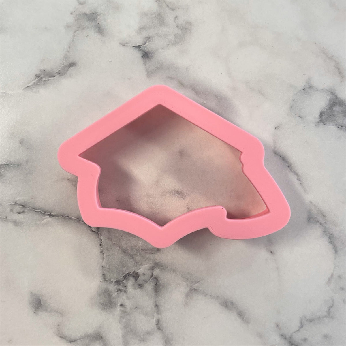 Pink silicone mini grad cap cookie cutter from flour box club for graduation themed baking projects