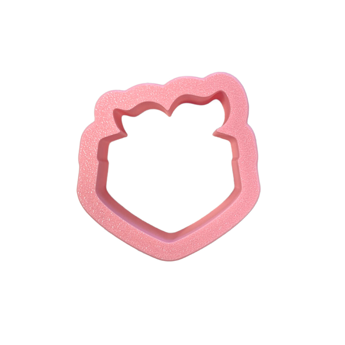 Pink glittery plastic mini handkerchief cookie cutter shaped like a shield with cat ears for baking use
