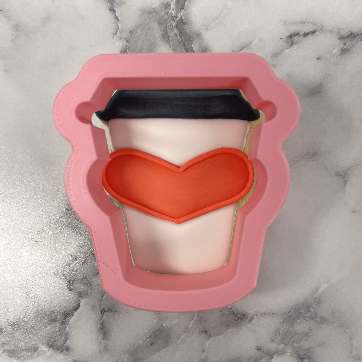 Mini latte with heart cookie cutter pink silicone coffee cup shape with black lid and orange heart design