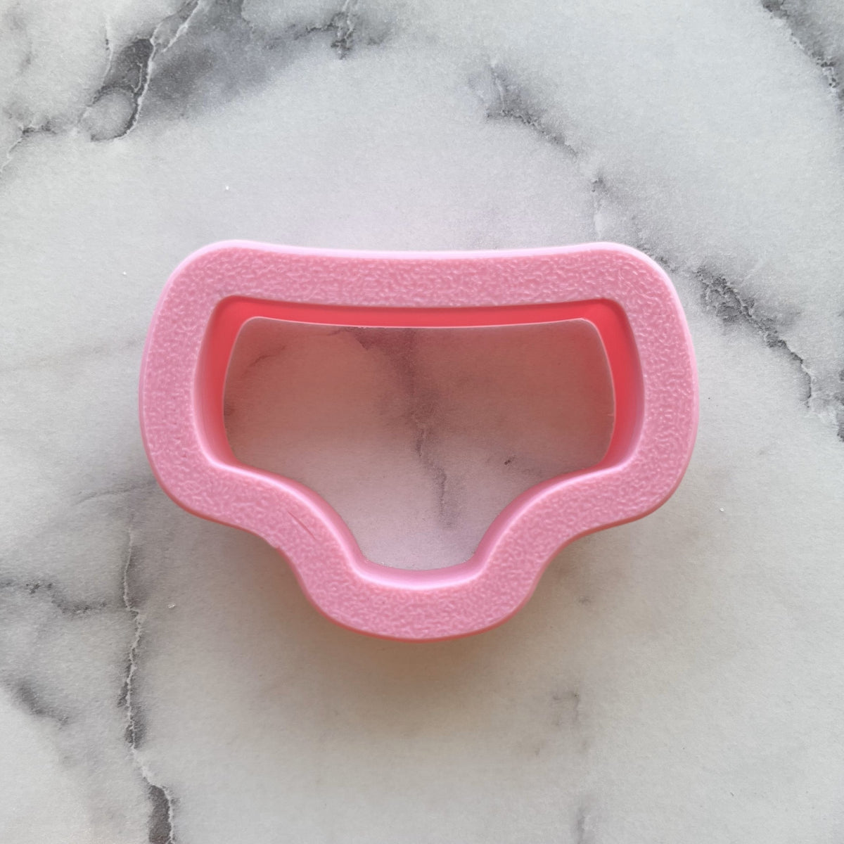 Pink plastic mini underpants cookie cutter shaped like a pair of underwear for baking and crafts