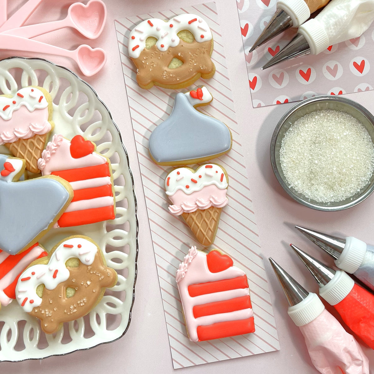 Mini heart ice cream cone cookie cutter with delicate pink and white frosted cookies decorated with red sprinkles