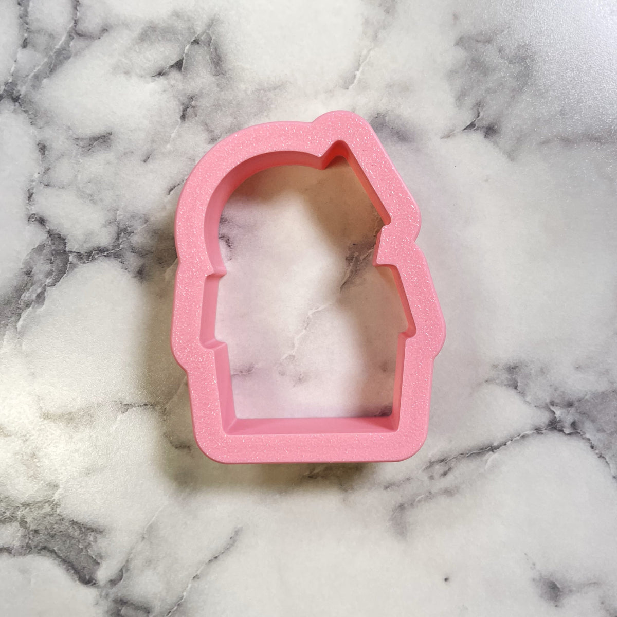 Pink glittery silicone cookie cutter shaped like a chubby haunted house character head for mini cute cookies