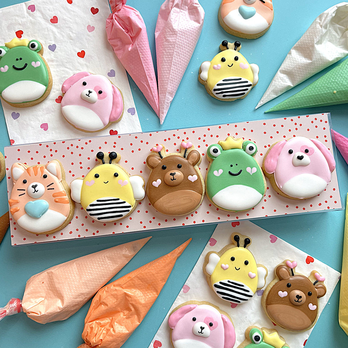 Cute pastel-colored animal-shaped sugar cookies with fondant faces made using valentine 2025 cookie cutter set