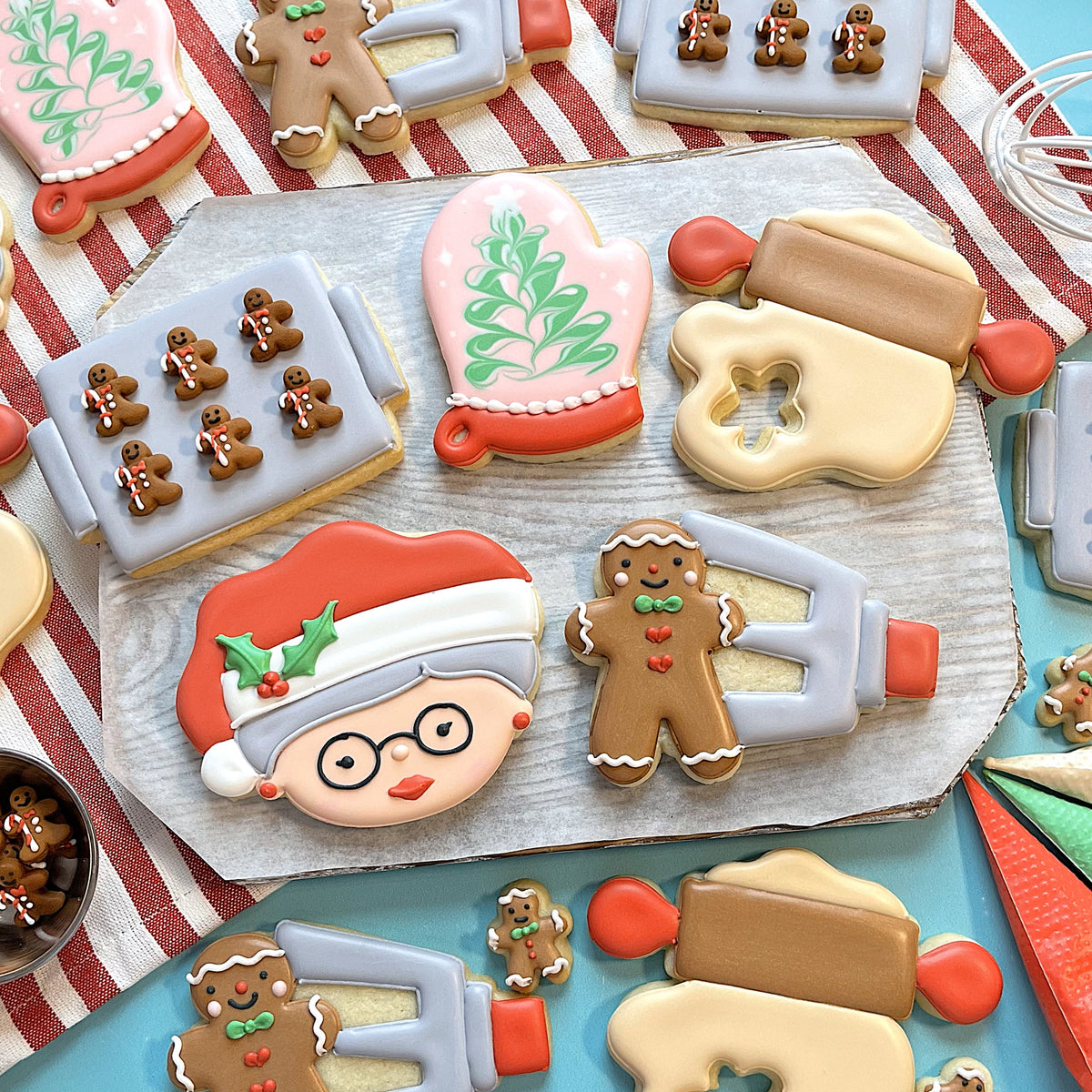 Oven mitt cookie cutter shaped like a festive gingerbread man with brown sugar glaze red heart buttons and green bow tie details