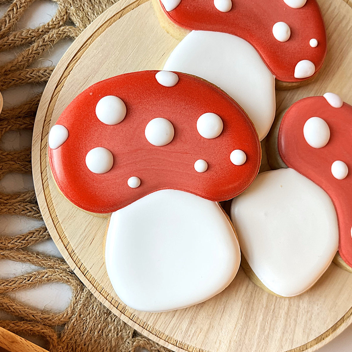 Red and white frosted mushroom shaped cookies made with mushroom pumpkin bucket flour box club flip cookie cutter