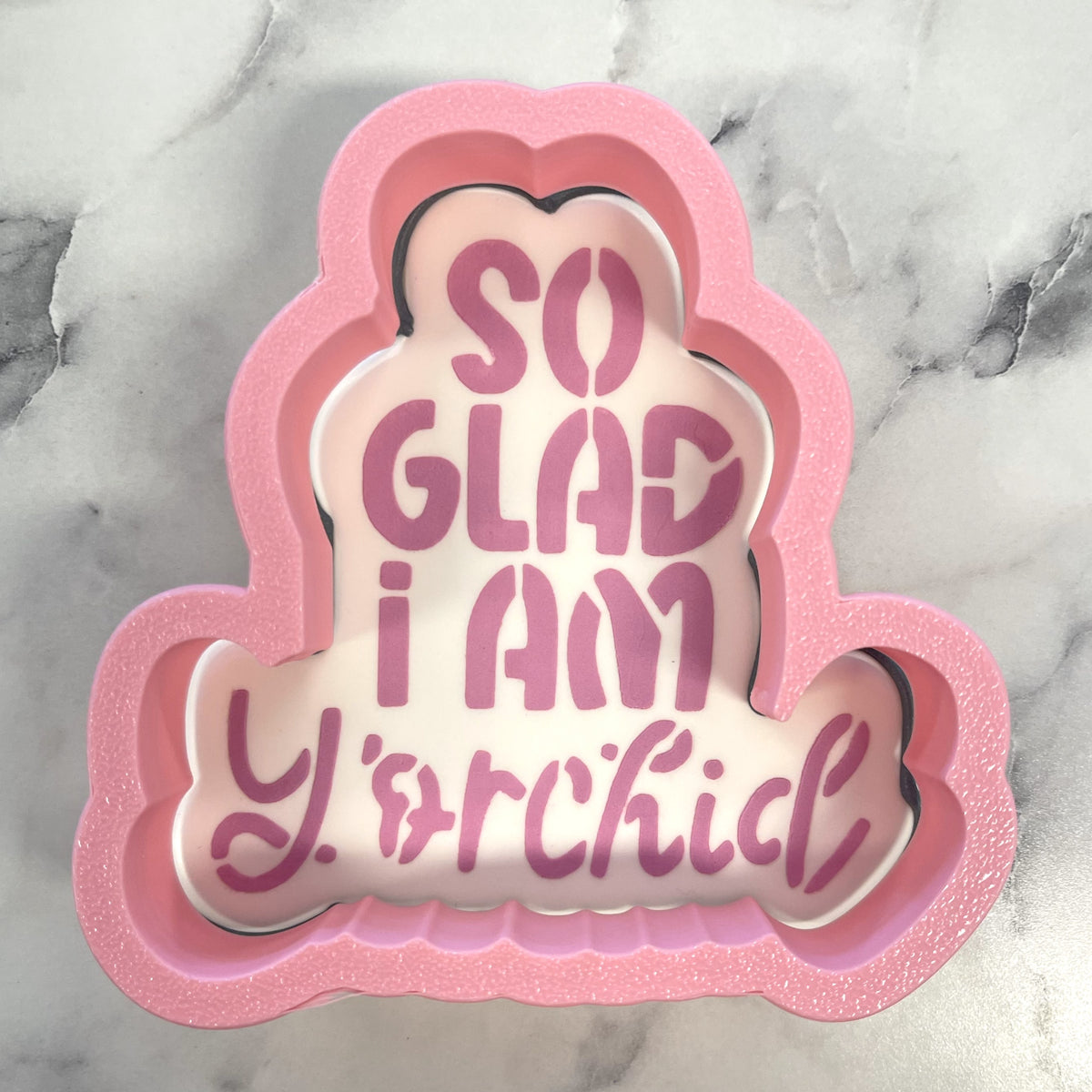 Pink glittery foam cloud-shaped cookie cutter with so glad i am yorchid pink lettering and stencil plaque design
