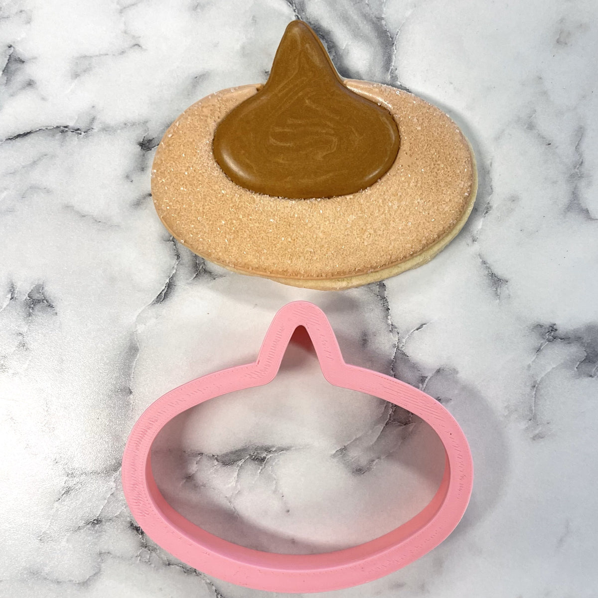 Pink plastic poop emoji shaped cookie cutter from pb blossom for fun baking and decorating treats