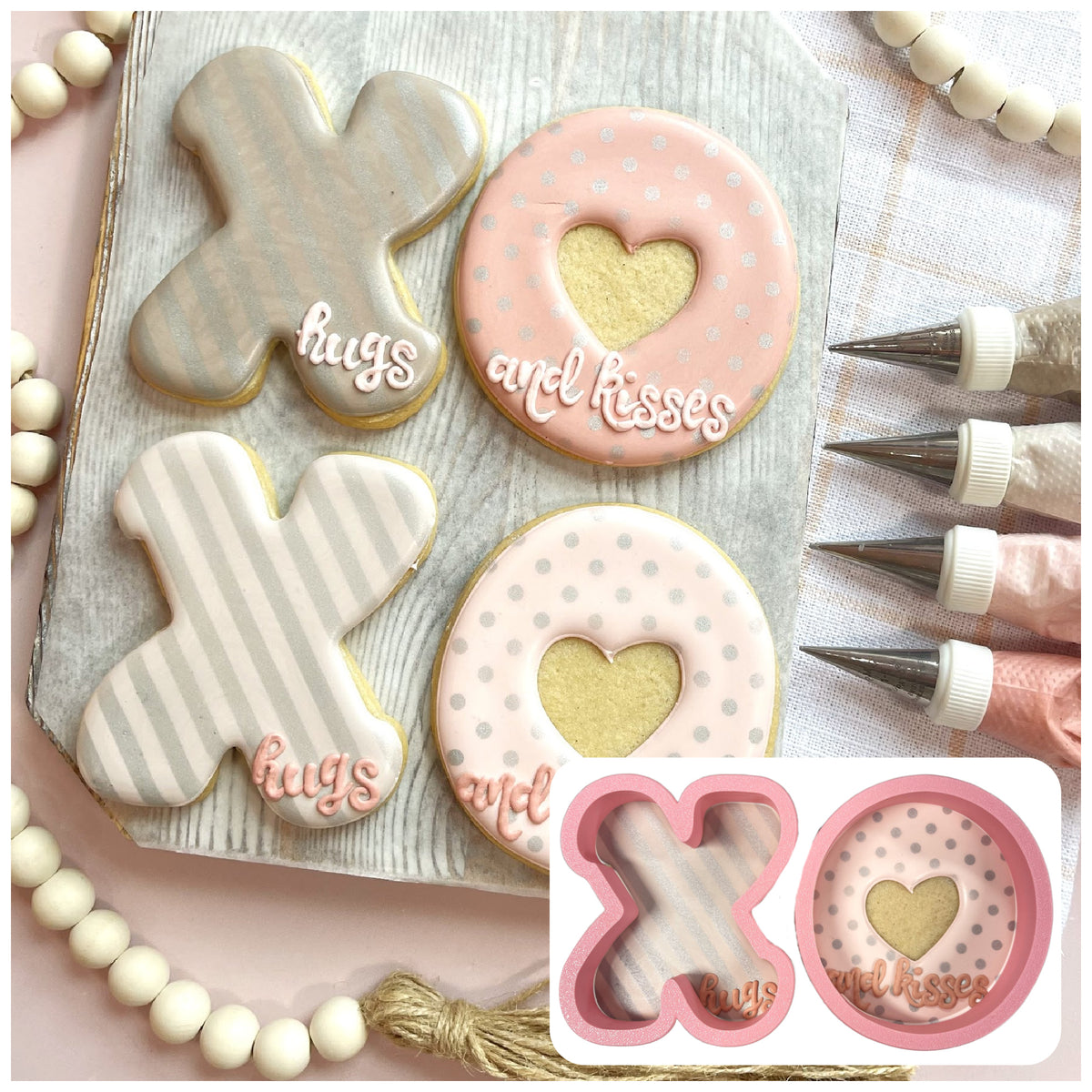 Pink and silver frosted sugar cookies shaped like xo with heart cutouts and white icing script hugs and kisses using xo cookie cutter bundle