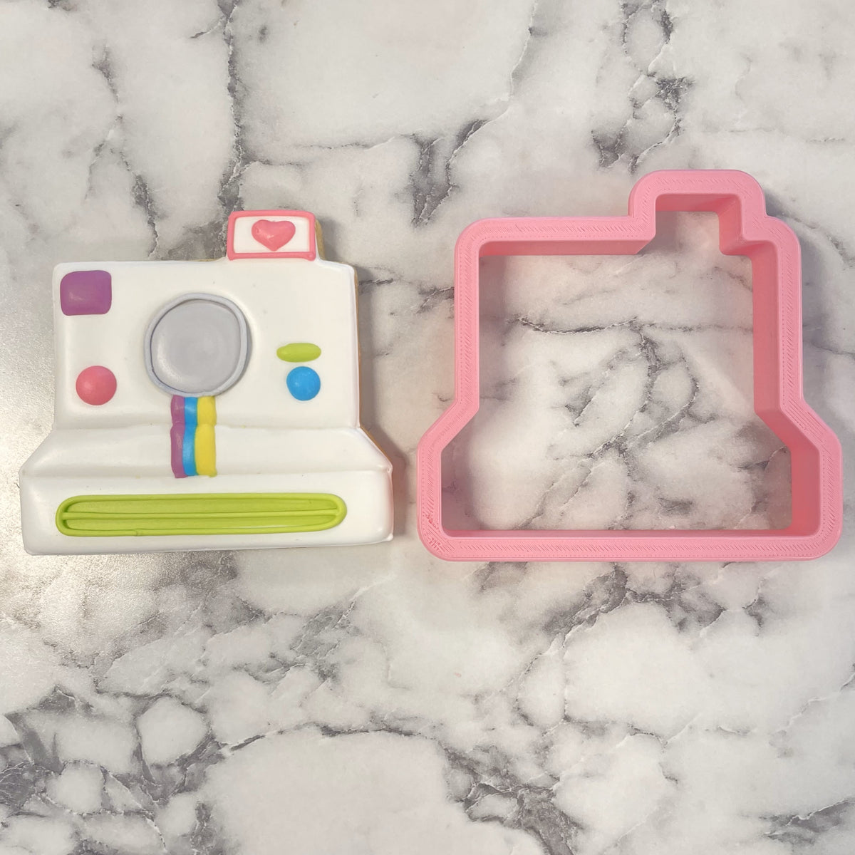 Retro camera cookie cutter white plastic polaroid shape with colorful accents and pink heart detail on top