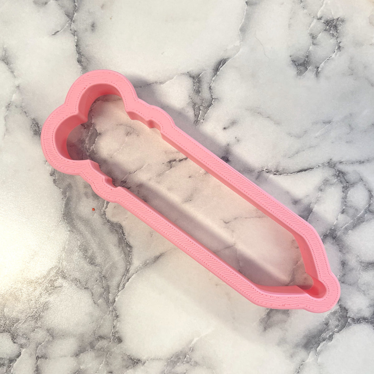 Retro click pen cookie cutter featuring a pink silicone crystal holder with a marbled quartz stone inside