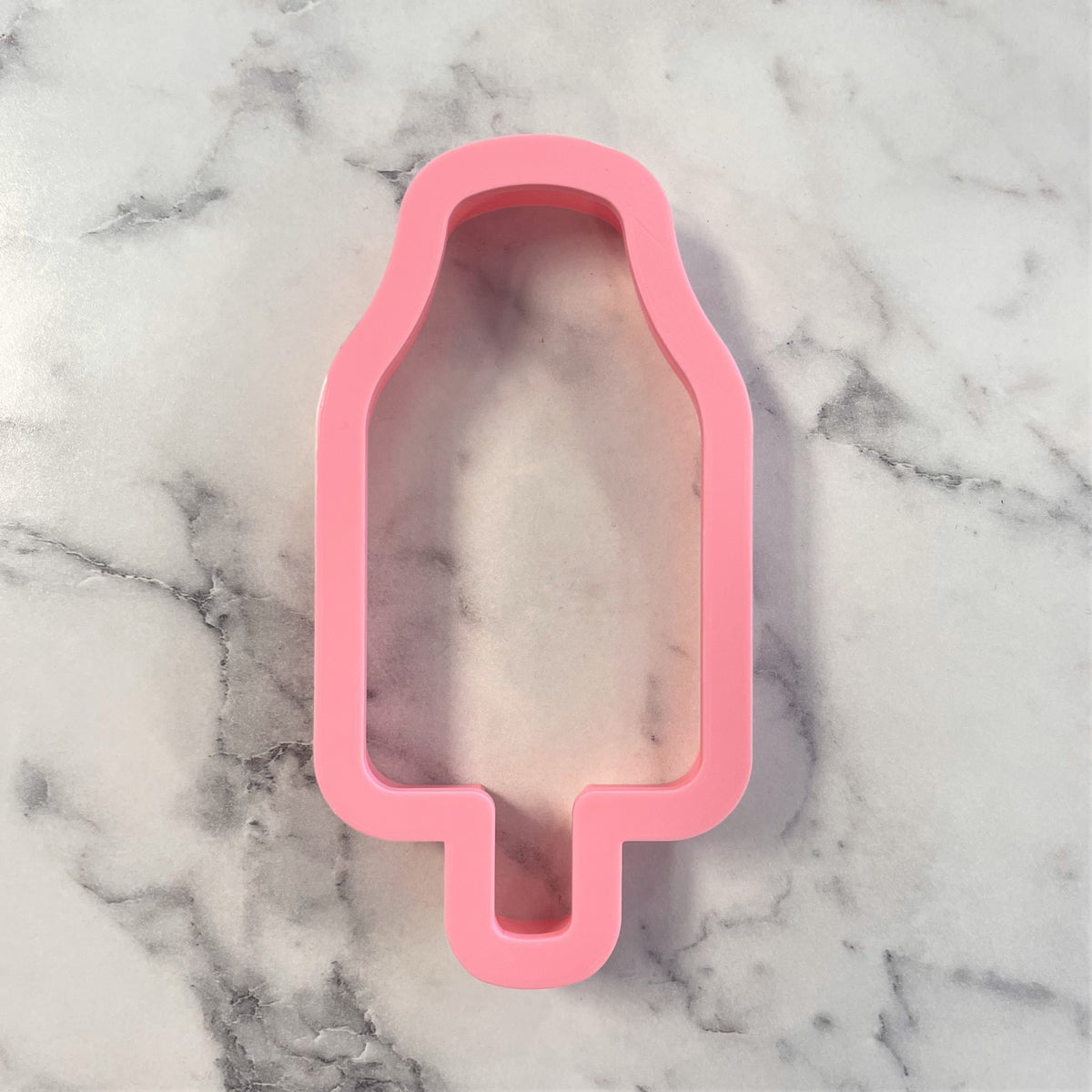 Pink silicone popsicle shaped cookie cutter from rocket pop flour box club for baking and crafting projects