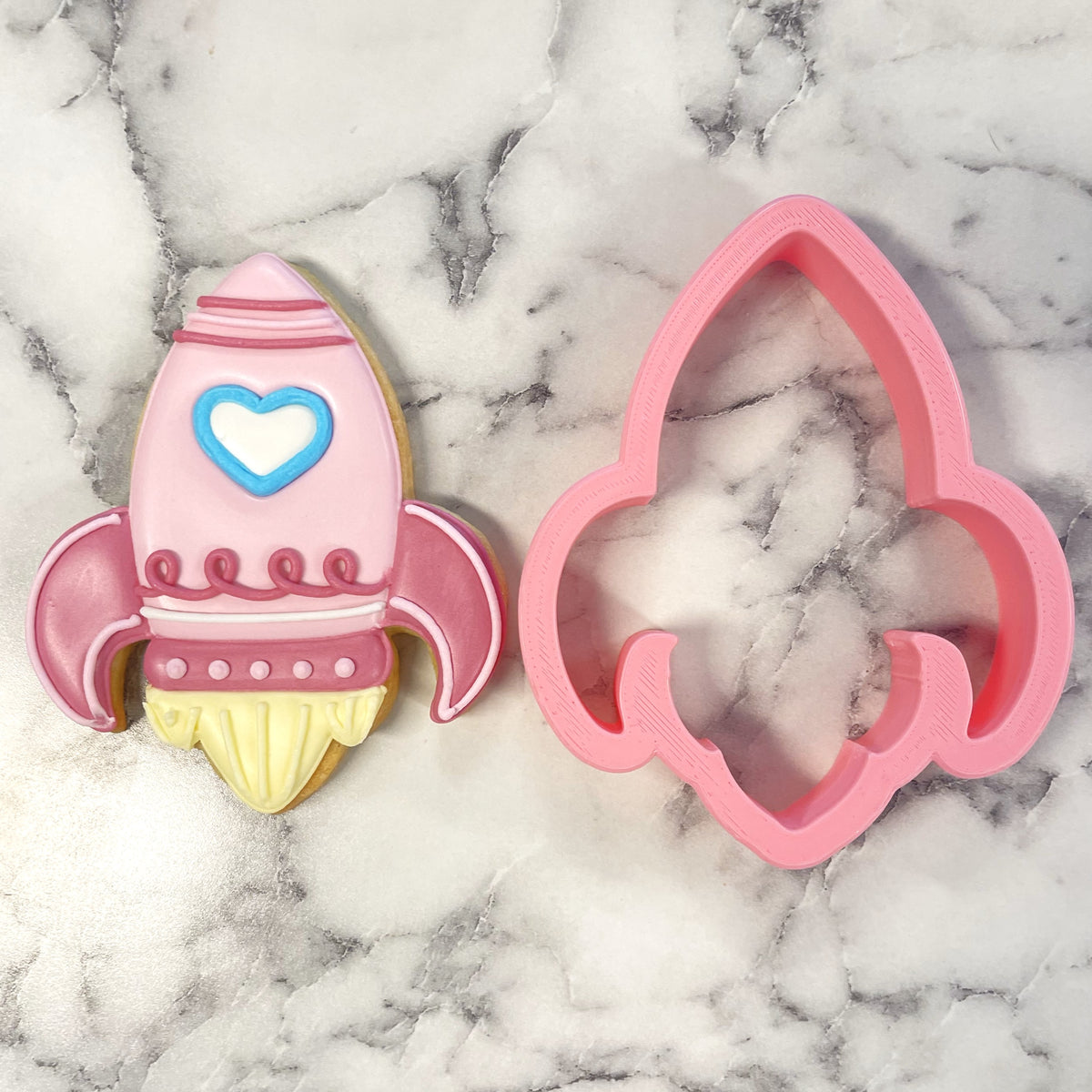 Pink rocket valentine cookie cutter with heart detail designed for themed baking and crafting projects
