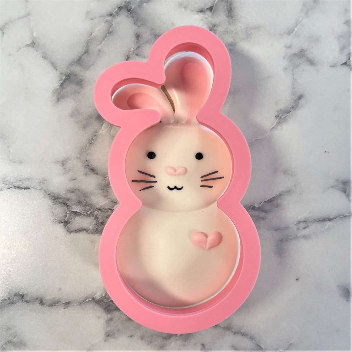 Pink bunny-shaped silicone cookie mold with cartoon face and heart detail from bunny roly poly flour box club