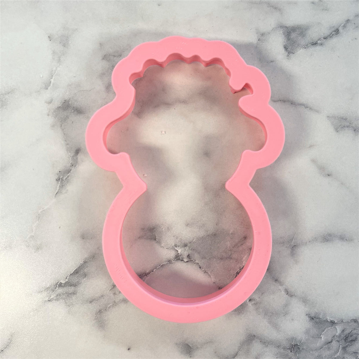 Pink silicone mold shaped like a stylized baby bottle with scalloped edges for lamb roly poly flour box club cookie cutter