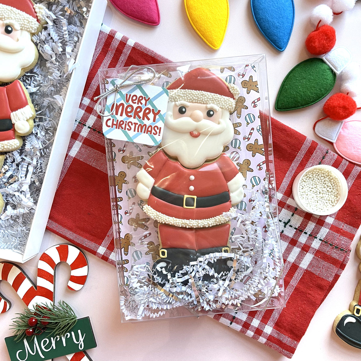 Red and white frosted santa claus cookie decorated with pearl sprinkles made with santa 3-in-1 multi-cookie cutter
