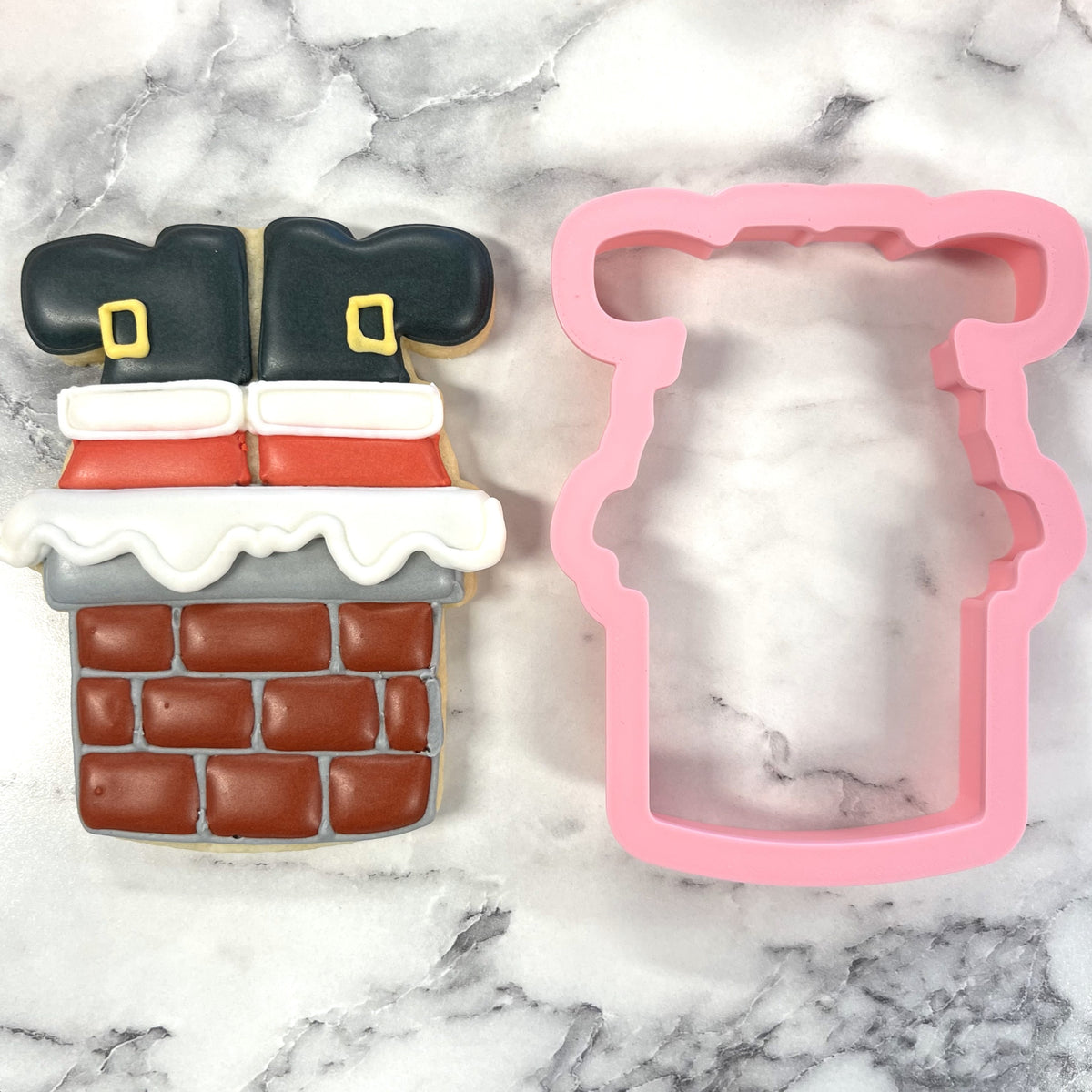 Pink silicone santa in chimney cookie cutter designed for holiday baking and festive treat shaping